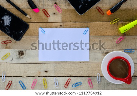 Office desk table with tablets phone, workspace mockup on a wooden table,cup of coffee and supplies,top view, Copy space.