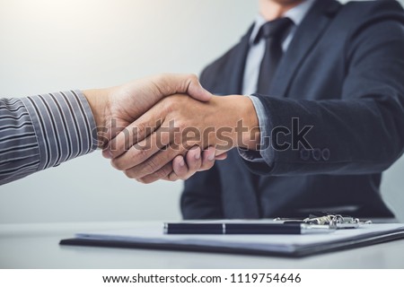 Handshake of cooperation customer and salesman after agreement, successful car loan contract buying or selling new vehicle. Royalty-Free Stock Photo #1119754646