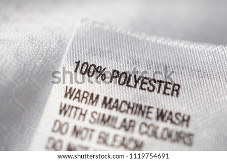 Polyester fabric Clothing label with laundry instructions Royalty-Free Stock Photo #1119754691