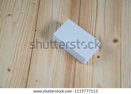 Blank business cards on wooden working table with copy space for add text ID. and logo, business company concept idea.