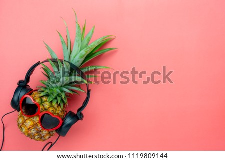Table top view aerial image of food for summer holiday season & music background concept.Flat lay object the pineapple listening radio by black headphone for sign of seasonal on modern pink paper.