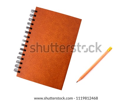 Book and pencil with white backdrop.