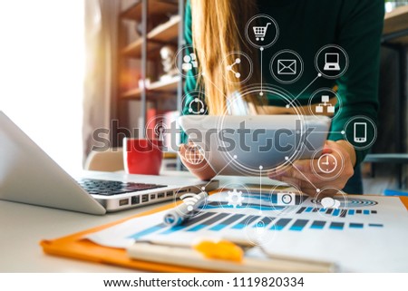 businesswoman or Designer using smart phone with laptop and digital tablet computer and document on desk in modern office with virtual interface graphic icons network diagram
