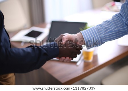 Business partnership handshake concept.Photo two coworkers handshaking process.Successful deal after great meeting.