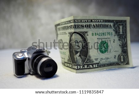 Photo camera and money isolated on white background