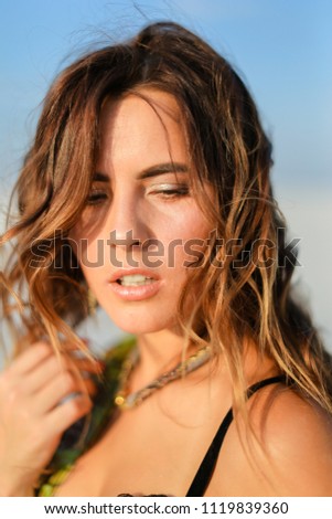 Portrait of beautiful woman wearing swimsuit in monophonic background. Concept of beauty and summer.