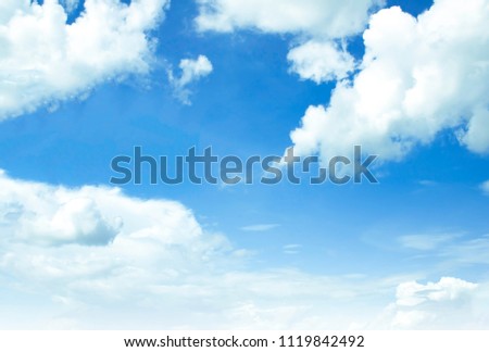 Sky background is vast with white clouds.