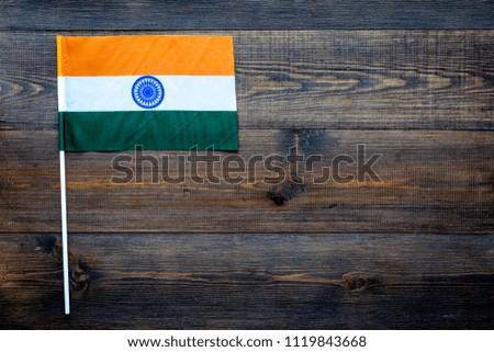 Indian flag concept. small flag on dark wooden background top view copy space