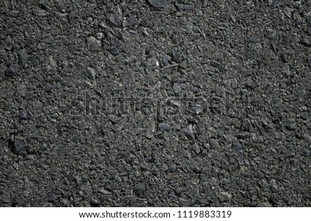 The surface of the road consists of rocks and asphalt
