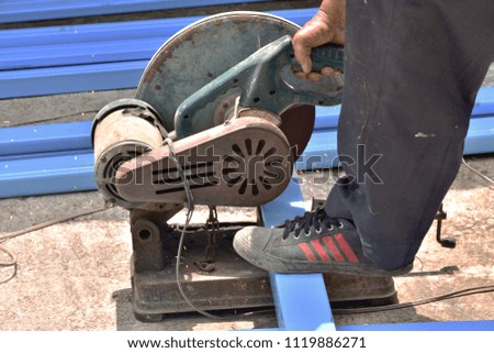 Hand of worker using old steel cutters for construction work.(Focus on steel cutters)