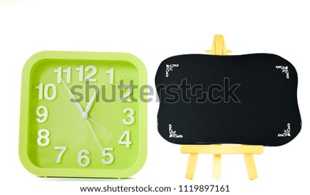 green square alarm clock and blackboard isolated on white background. selective focus.