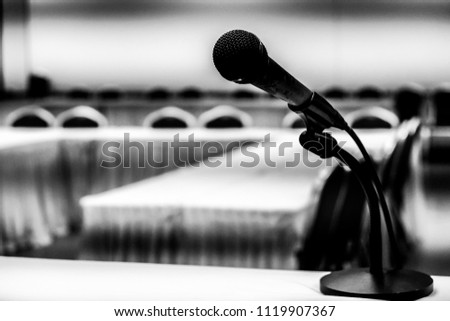 Close up old microphone in conference room.in the class blurred background.
