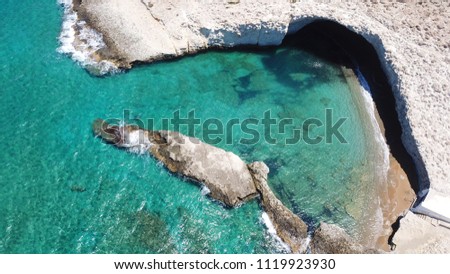 Aerial drone bird's eye view photo of volcanic cove of Alogomandra with turquoise clear waters and white rock, cave formations, Milos island, Cyclades, Greece