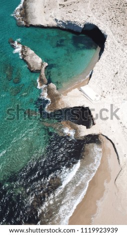 Aerial drone bird's eye view photo of volcanic cove of Alogomandra with turquoise clear waters and white rock, cave formations, Milos island, Cyclades, Greece