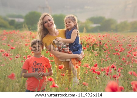 Mother and children in a poppy field
