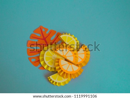 Fruits made from paper on a blue background. lemon. View from above. Children's creativity. Tropical party of Hawaii.