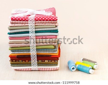 Pile of colorful folded textile Royalty-Free Stock Photo #111999758