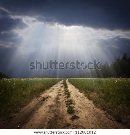 Rural road and the god ray Royalty-Free Stock Photo #112001012