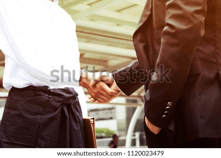 Business man working show hand shake success in the capital city.