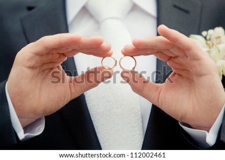 groom holding a gold rings Royalty-Free Stock Photo #112002461