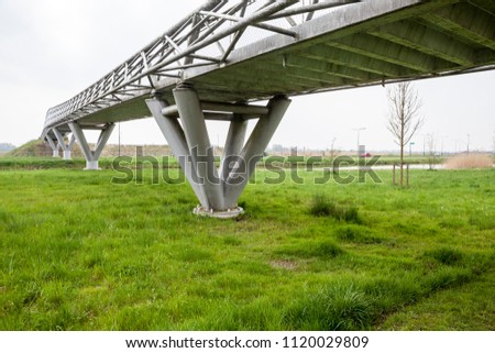 in the outskirts of the city this bicycle bridge runs over a busy motorway