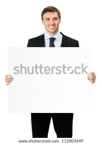 Happy smiling young business man showing blank signboard, isolated over white background