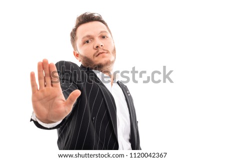 Portrait of business man showing stop gesture isolated on white background with copyspace advertising area