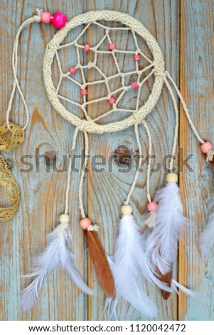 Dreamcatcher,with lavender american native amulet on wooden background