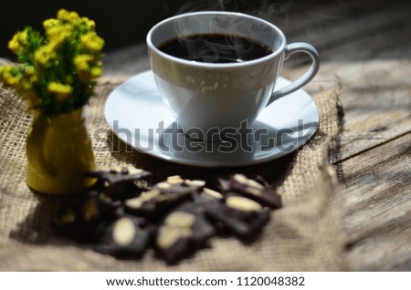 Cup of coffee and tasty cookies on wooden background. Tea time and breakfast concept.