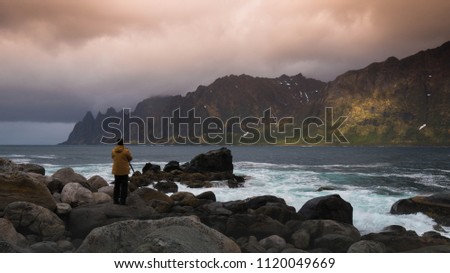 A photographer is taking a photo of the sea, Senja, Norway