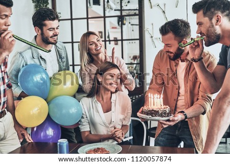 Hurry up to make a wish. Group of happy people celebrating birthday among friends and smiling while having a party  
