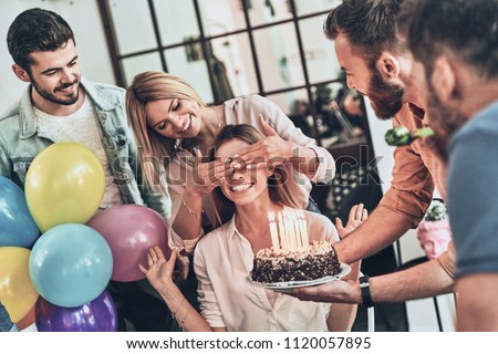 Surprise for her. Group of happy people celebrating birthday among friends and smiling while having a party       
