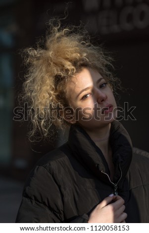portrait of beautiful girl walking through the city streets
