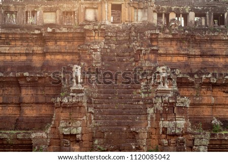 Ancient temple in Angkor Wat. Phimeanakas stair with stone statue in sunset light. Buddhist or hindu temple. Khmer architecture heritage. Tourist place of interest in Cambodia. Asia travel sightseeing