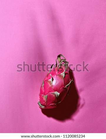Pink pitahaya on a pink background with a shadow