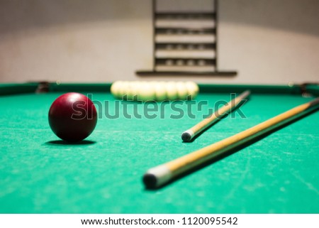 Russian billiards.Playing billiard. Billiards balls and cue on green billiards table.
