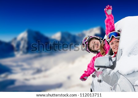 Winter holiday, ski, travel - happy family on the road for winter holidays