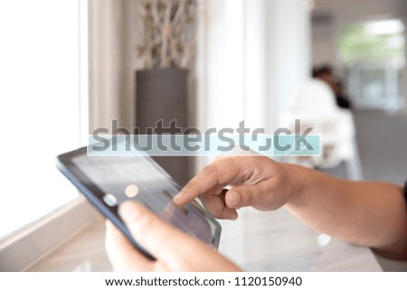 Closeup of female using her digital tablet in coffee shop cafe and restaurant for searching data internet and information networking concept.