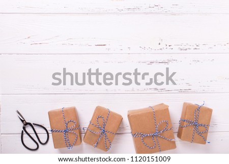 Wrapped  gift boxes with presents on textured wooden background. Selective focus. Place for text. Flat lay.