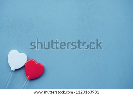 Red and white hearts on a blue background, love concept  copy space.