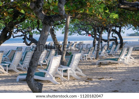 Empty beach chairs on the beach of Nusa Dua, Bali