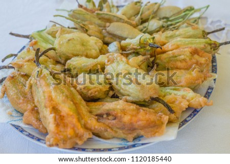 close up of deep-fried pumpkin flowers on the plate