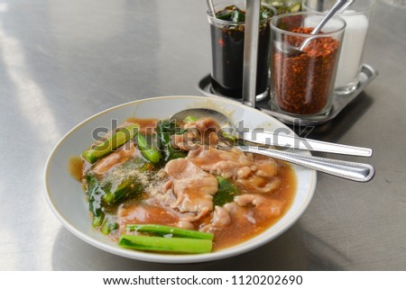 Stir fried wide rice noodles with pork and Chinese kale in gravy, Bangkok street food Royalty-Free Stock Photo #1120202690