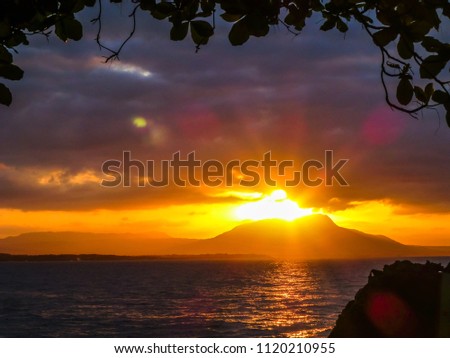 Sun rays shining behind mountain in the sunset. Dominican Republic.