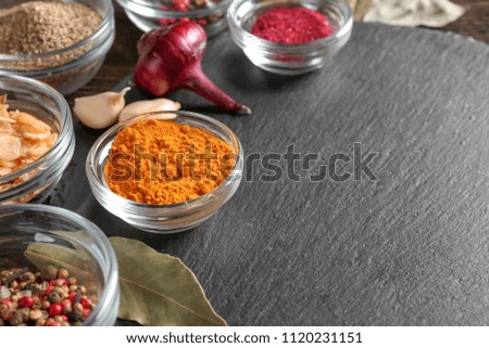 Slate plate with various spices on table