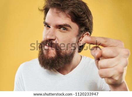 a man with a beard is pointing his finger to the side                        