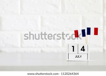 July 14 Wooden calendar and France Flag Concept France national day with space for your text