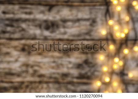 Blurred view of glowing Christmas lights on color background, top view