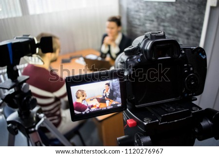 camera on the set of a business meeting between a man and a woman Royalty-Free Stock Photo #1120276967