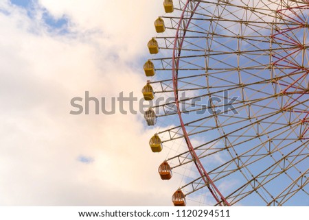 Big giant funfair ferris wheel against sky background